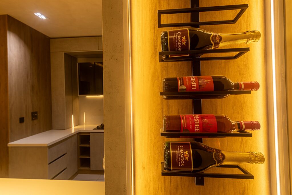 Brum Height 9: Wall-mounted cup rack beside the open-plan kitchen